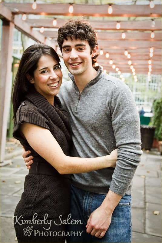 Sarah and David under trellis with lights