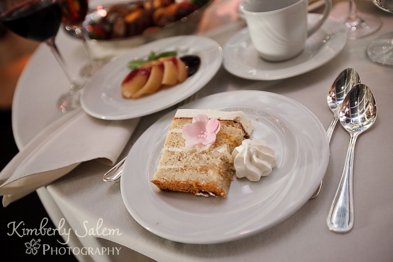 table set with slice of wedding cake and sugar flower