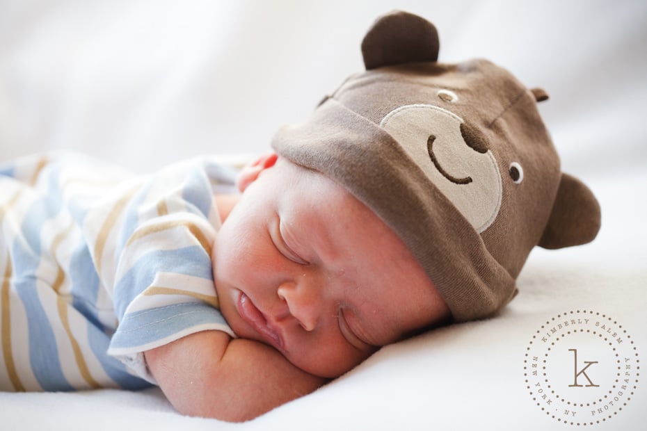 infant wearing bear hat