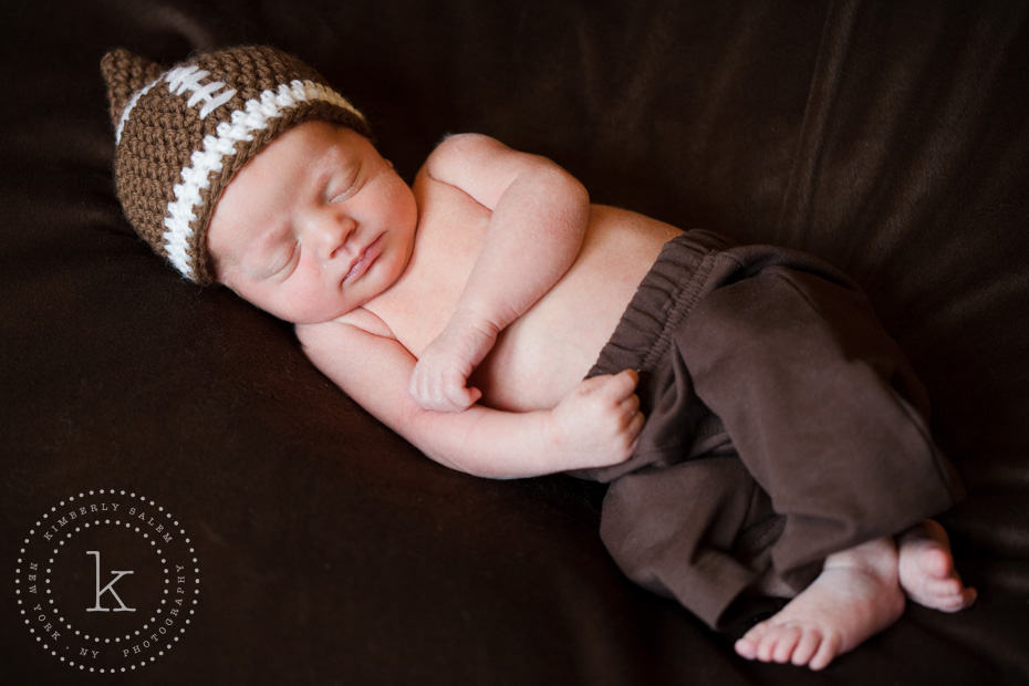 infant wearing crocheted football hat