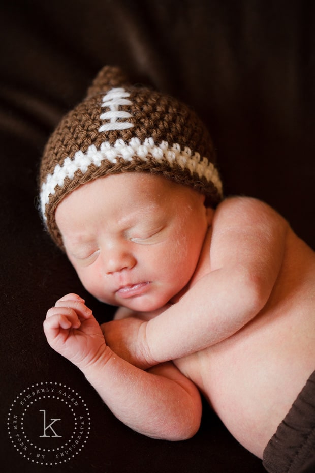 infant wearing crocheted football hat