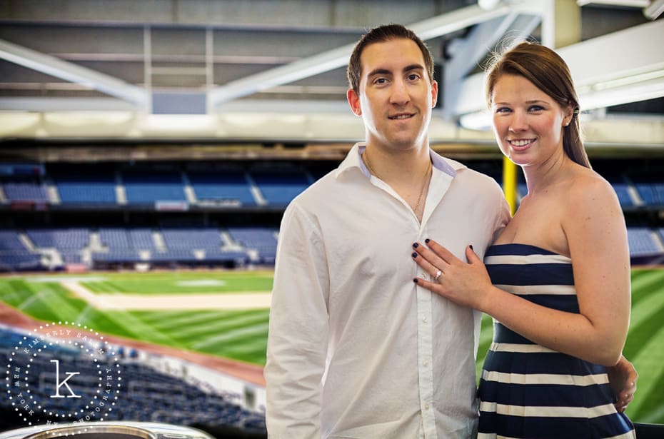 engaged couple at yankee stadium - with field in background