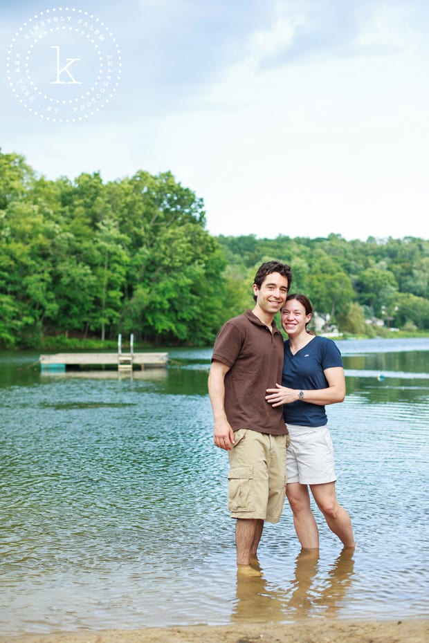 engaged couple standing in lake