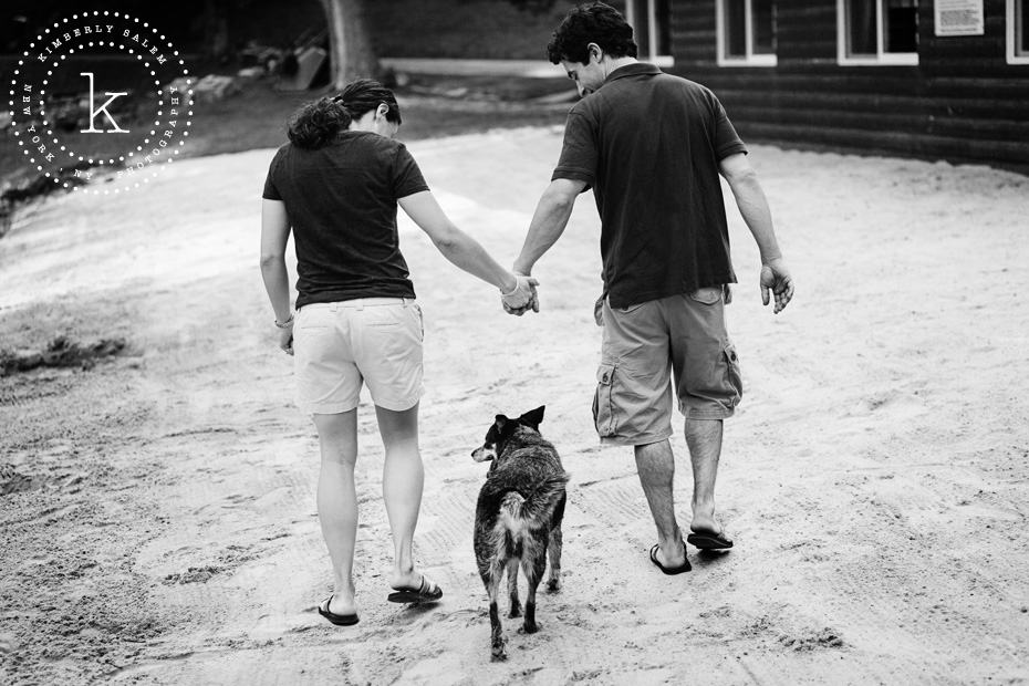 engaged couple hand in hand, with dog