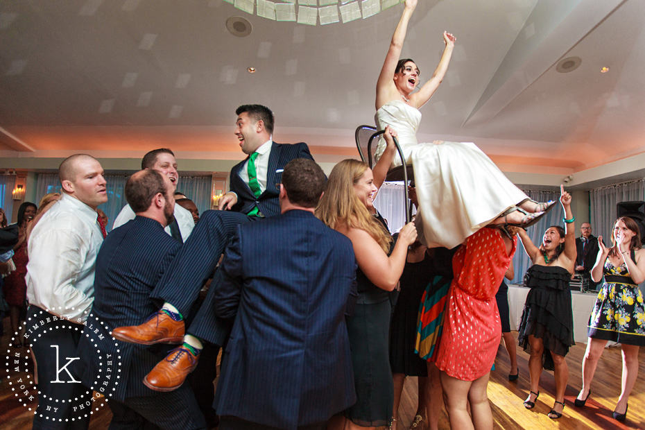 Bride and groom on chairs during the Hora