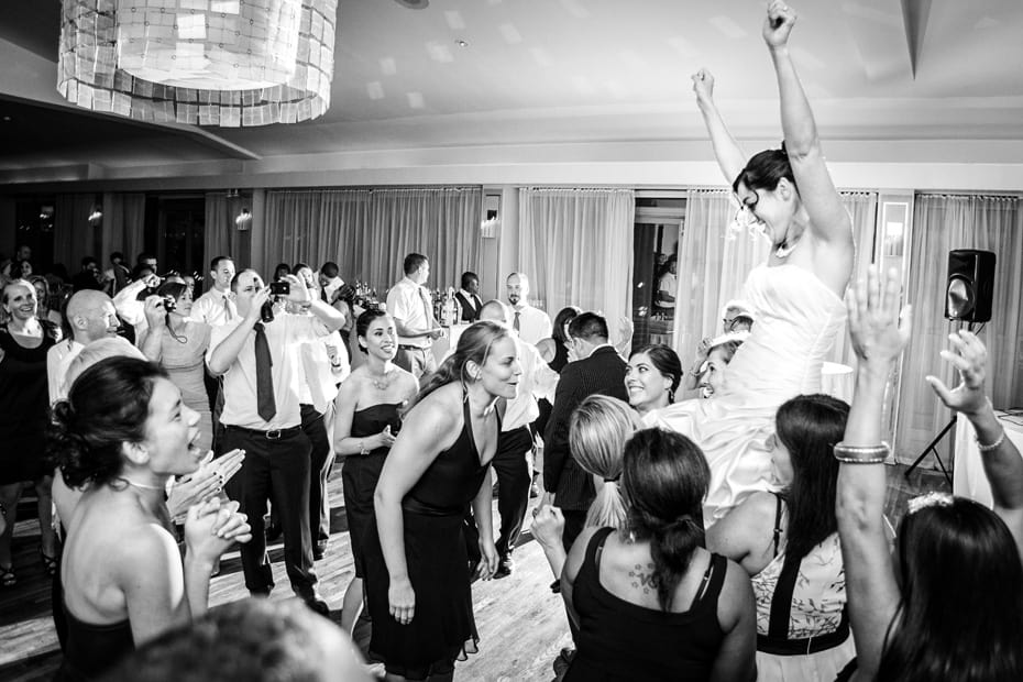 Bride being lifted up at reception