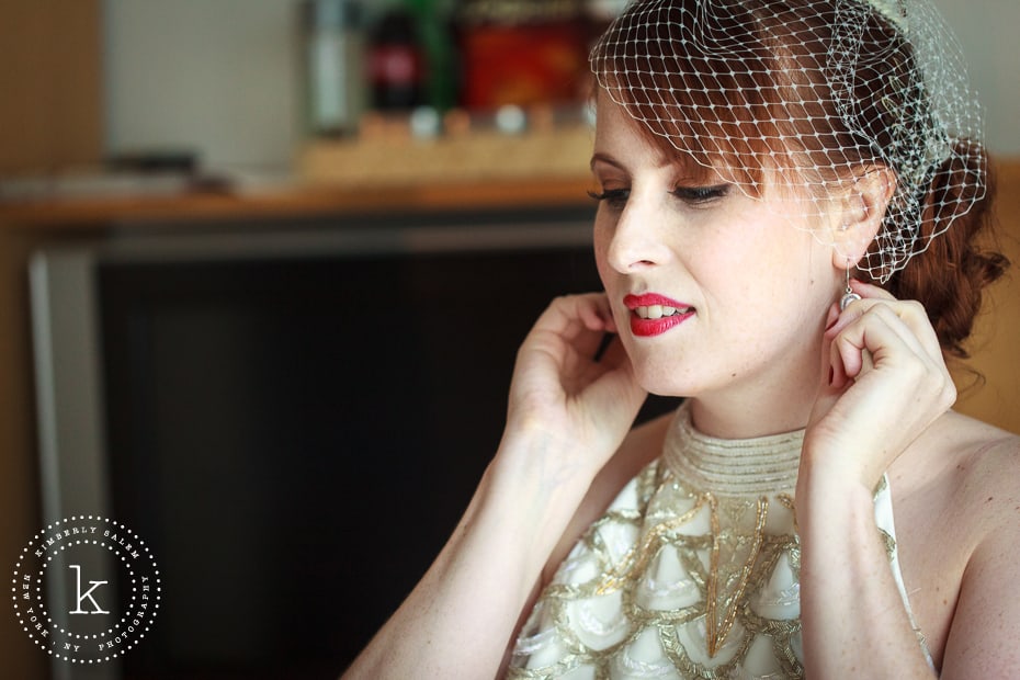 bride getting ready - putting on earrings