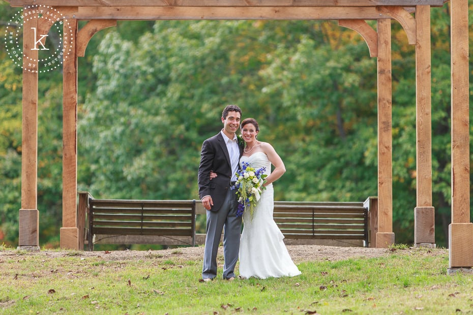 Bride and groom under pergola