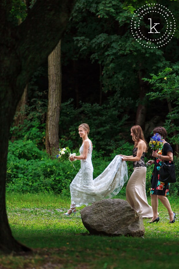 Bride walking towards the aisle with attendants - outdoor wedding