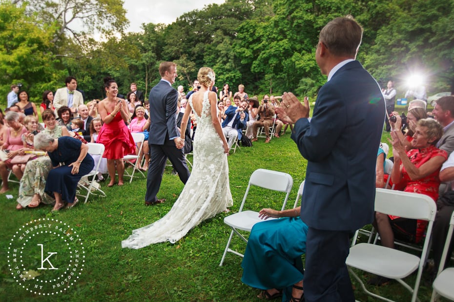 Bride and groom walk back down the aisle together