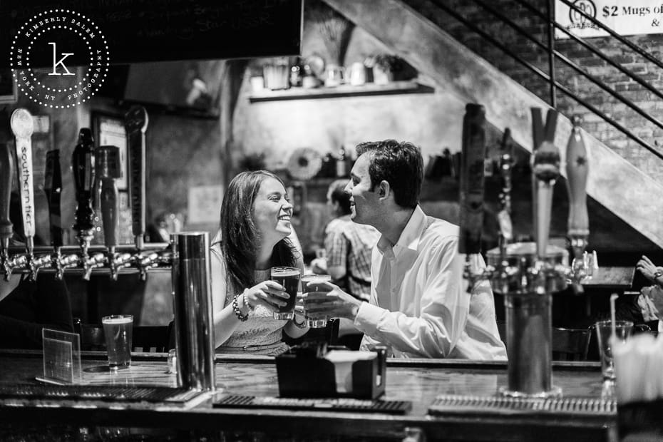 engaged couple with beers at the bar of The Stag's Head in NYC