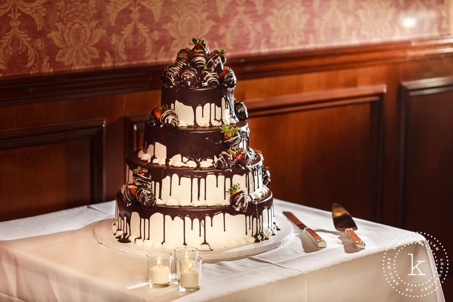 wedding cake with chocolate covered strawberries on top