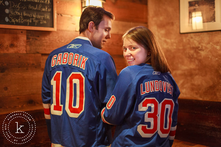 engaged couple wearing NY Rangers jerseys at The Stag's Head in NYC