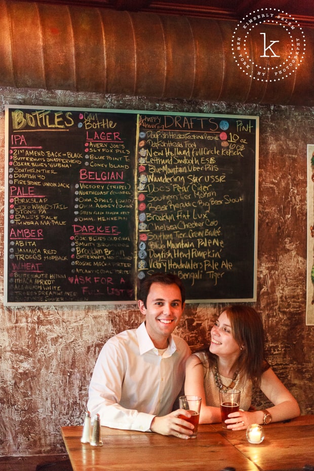 engaged couple by the beer menu at The Stag's Head in NYC