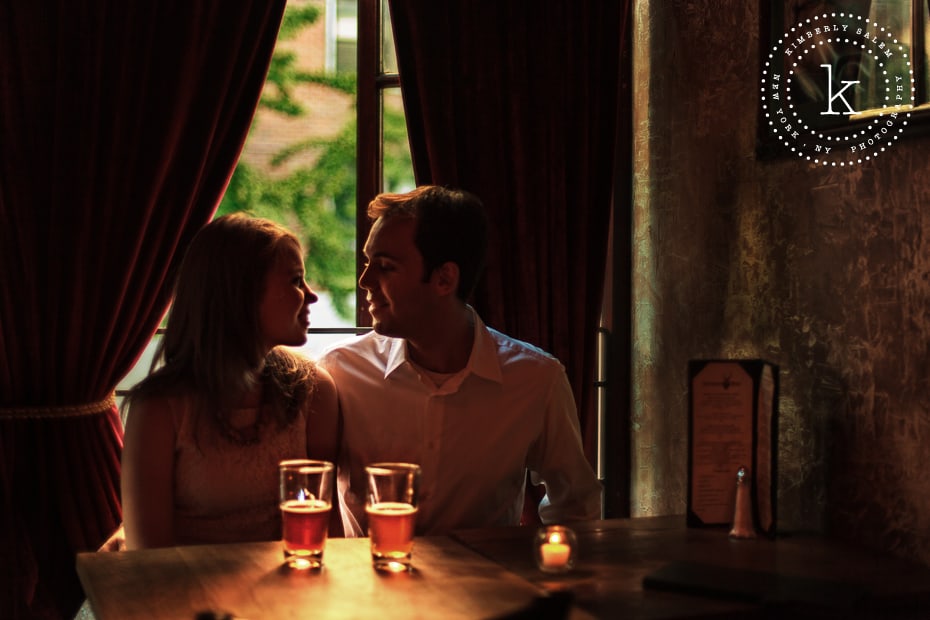 engaged couple by the window at The Stag's Head in NYC