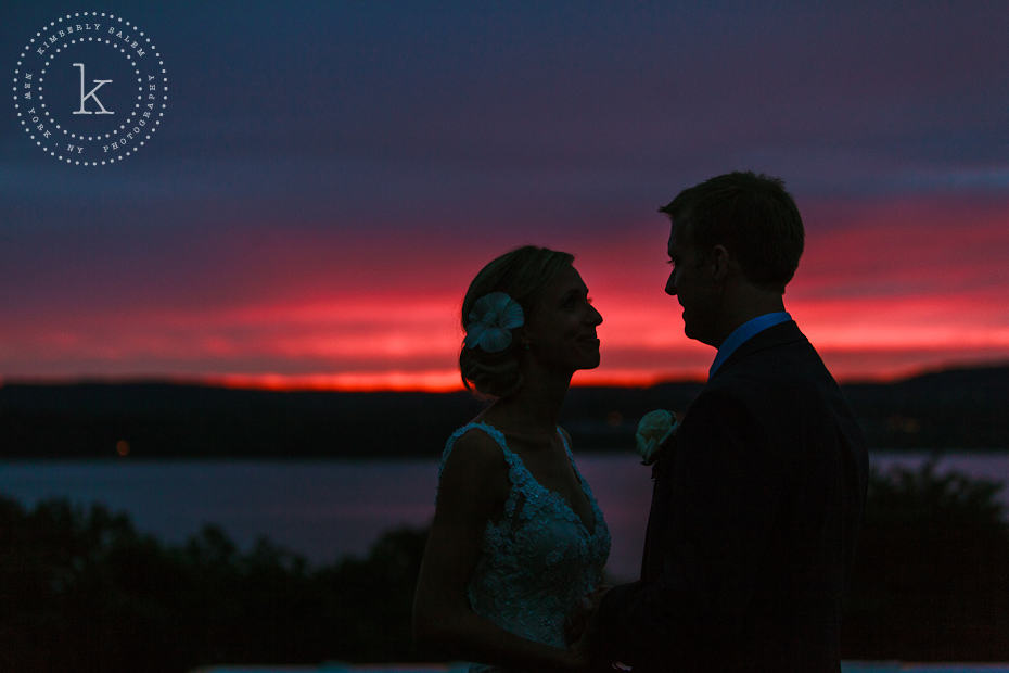 Bride and groom in front of brilliant sunset on the Hudson River - silhouette