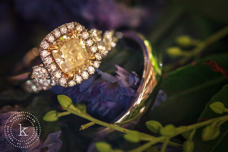 Engagement and wedding ring detail with flowers - yellow diamond