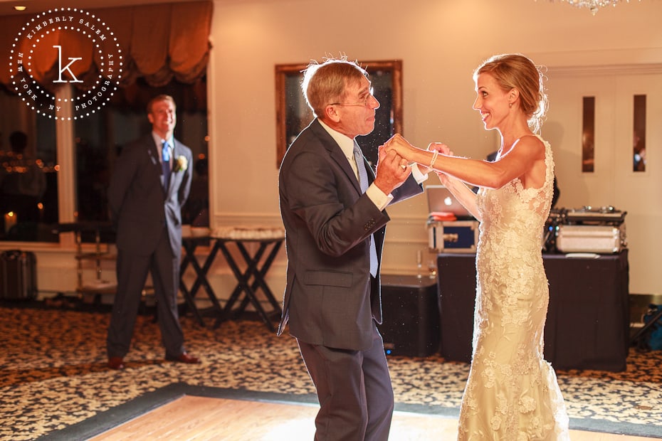 Bride dances with father as new husband looks on