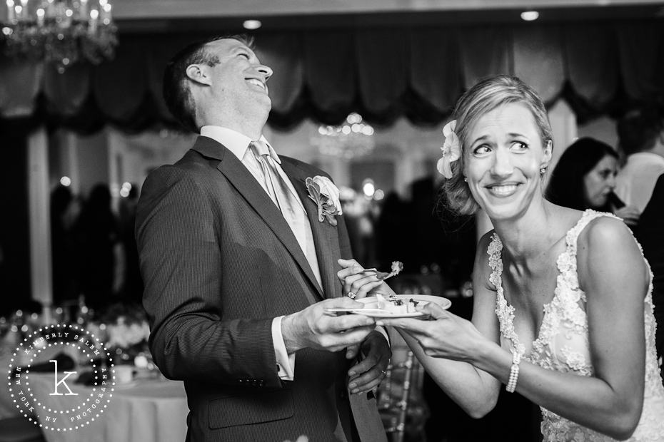 Cake cutting at wedding - laughing bride and groom