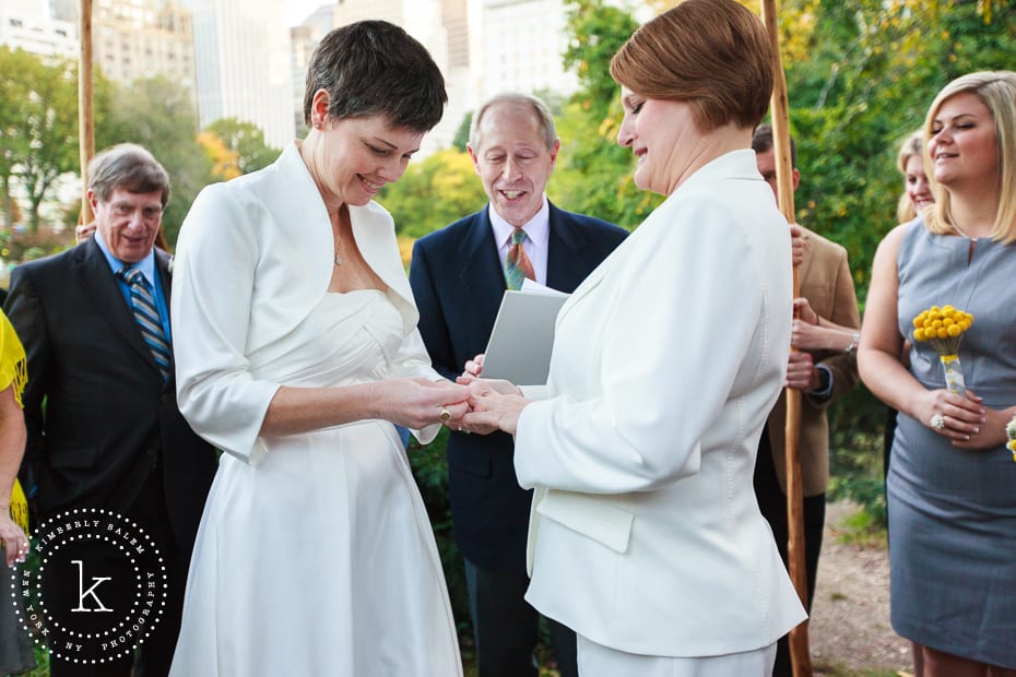 brides exchanging rings during wedding ceremony