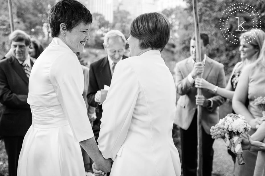 brides laugh during their wedding ceremony