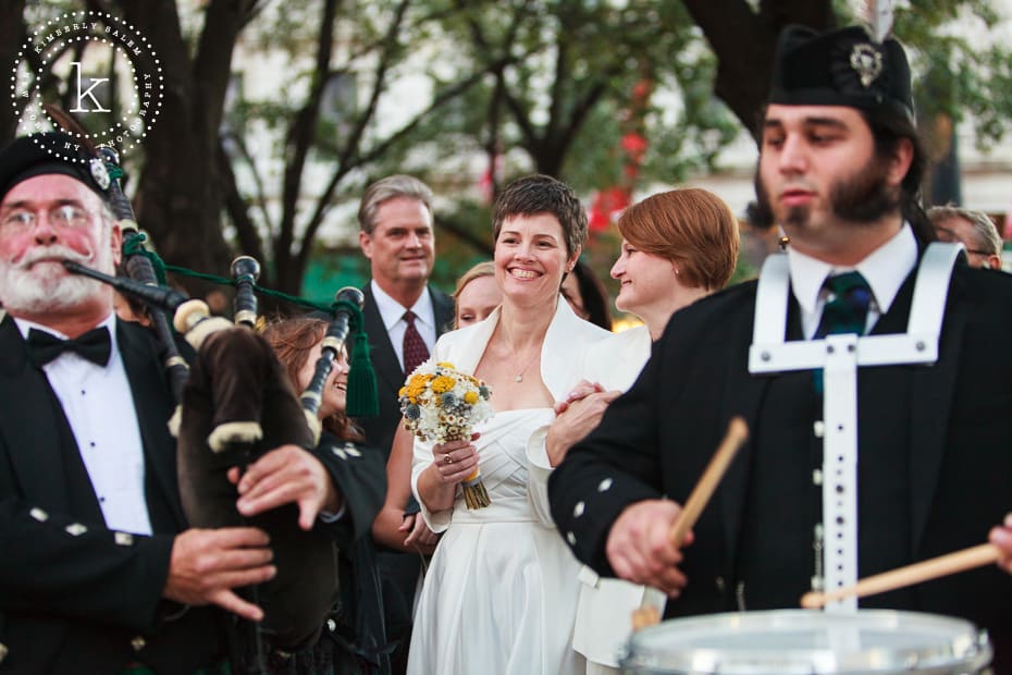 brides walk behind two bagpipers