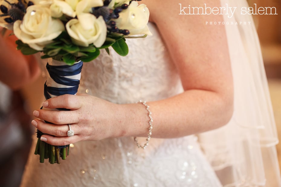 engagement ring detail with bouquet and dress