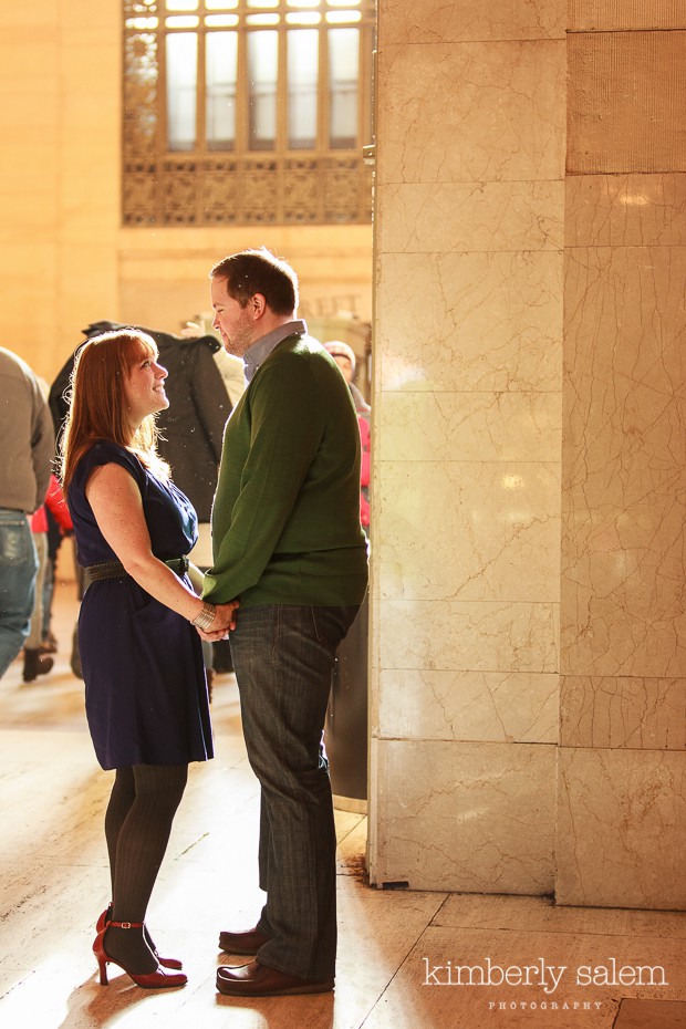 engaged couple in Grand Central station holding hands