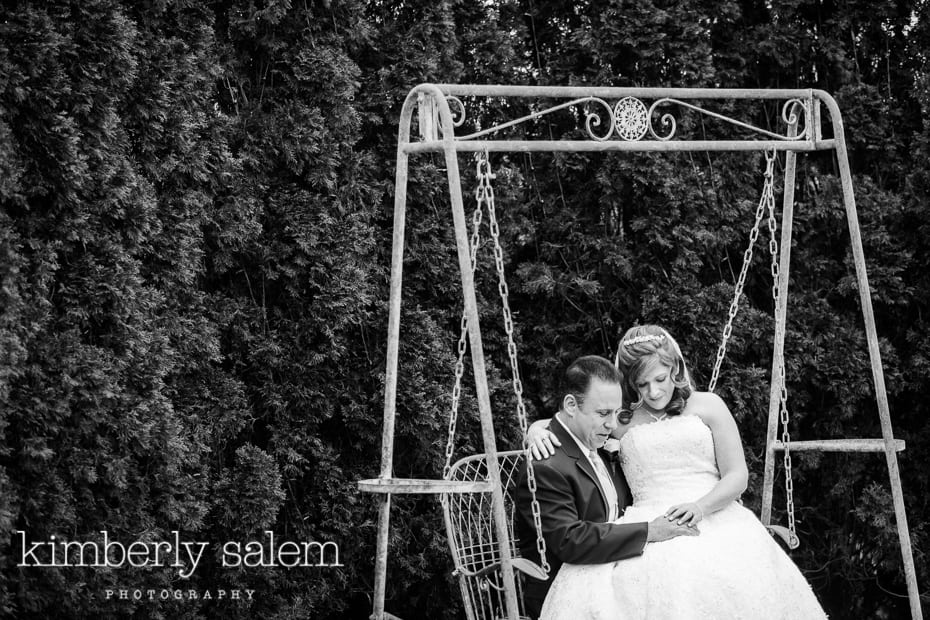 bride and groom share a moment on a swing