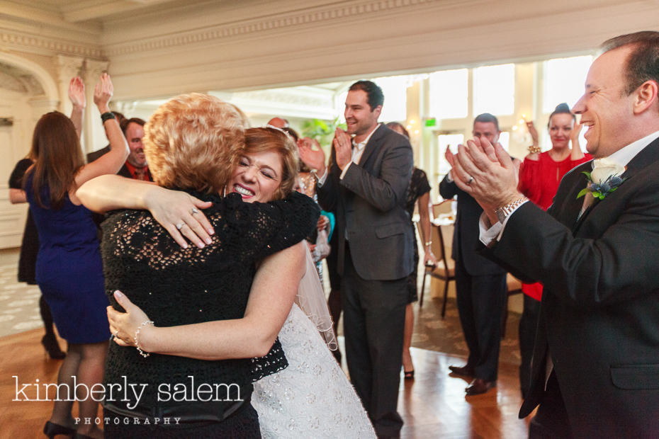 bride hugging a guest on the dance floor