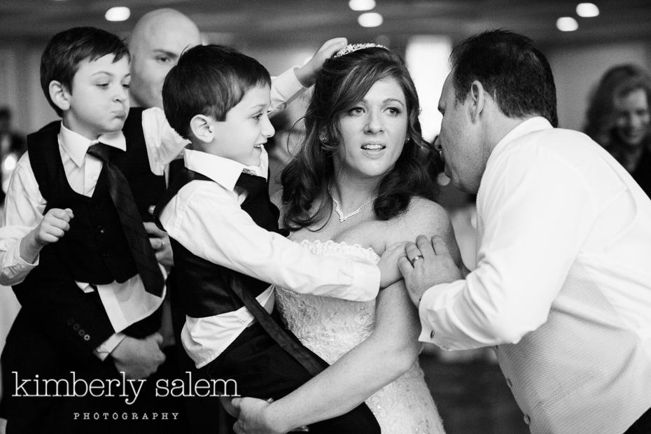 mischievous boy trying to take bride's headpiece off