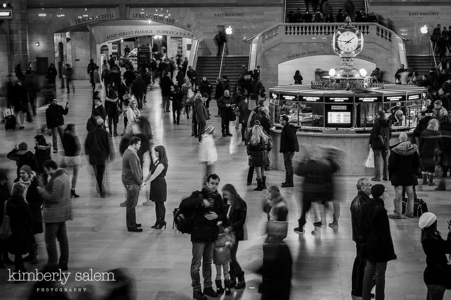 engaged couple in grand central station - motion blur around them