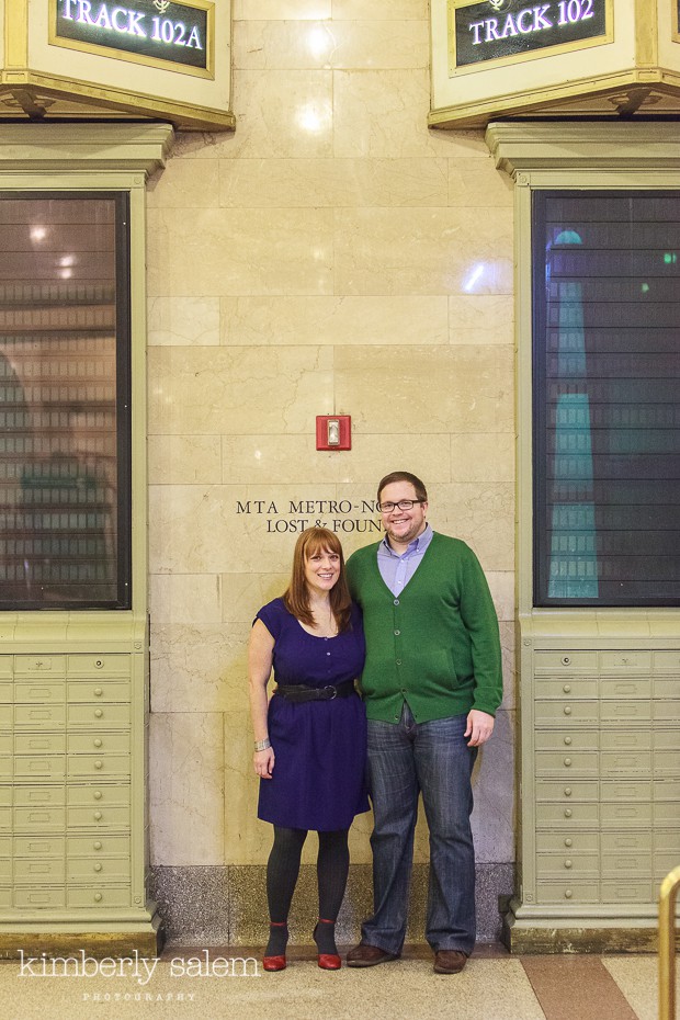 engaged couple by info boards in Grand Central