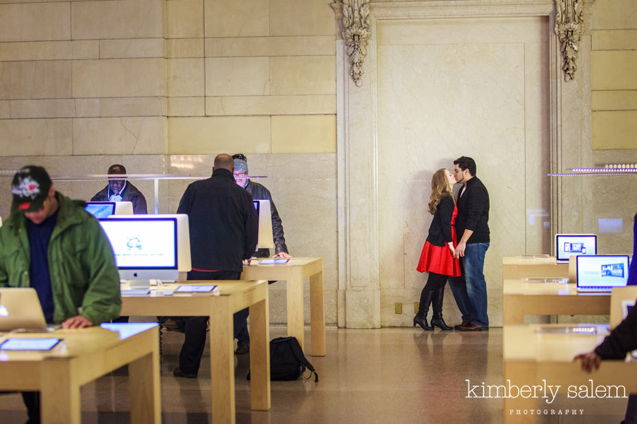 engaged couple kisses in the Grand Central apple store