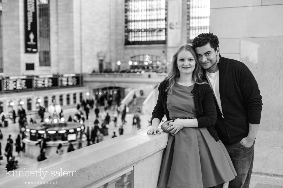 engaged couple overlooking the main floor in Grand Central