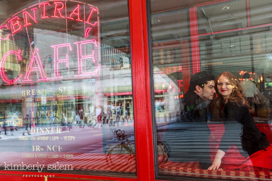 engagement photos through the window of cafe