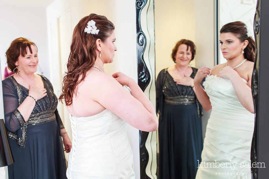 mother of bride watching her get ready