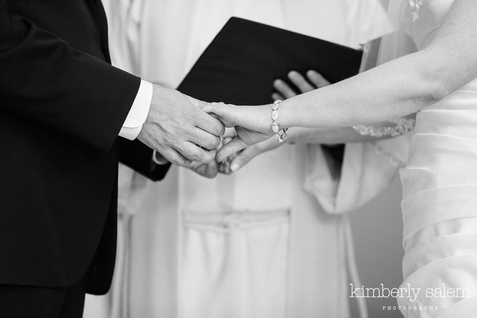 bride and groom hold hands during ceremony