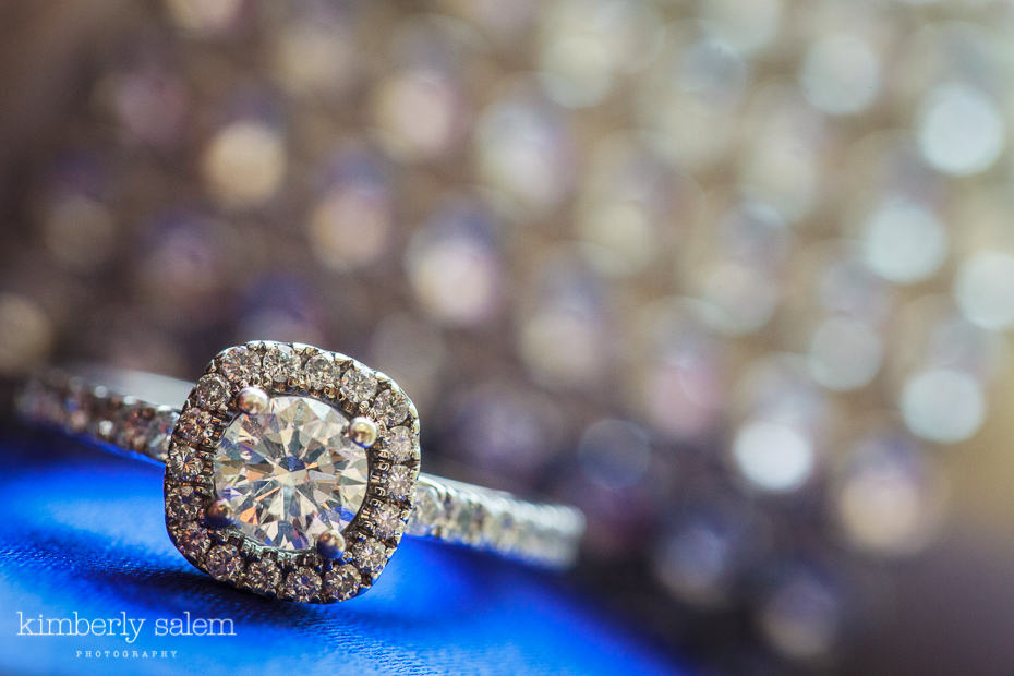 engagement ring on blue with sparkly background