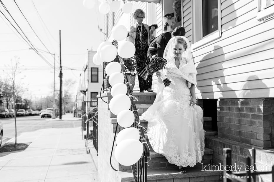 bride walking down stairs - white balloons