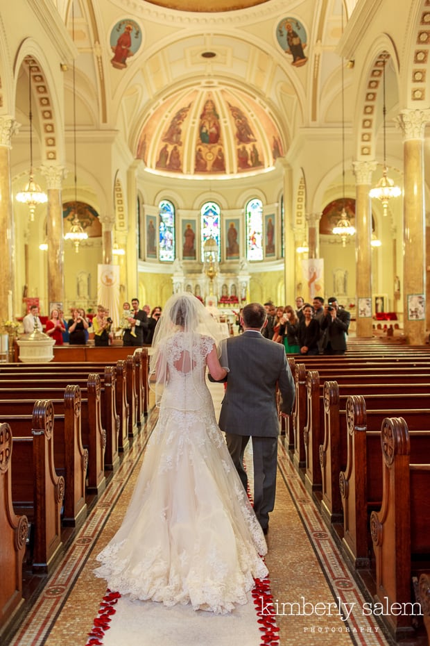 bride and her father walking down the aisle in church