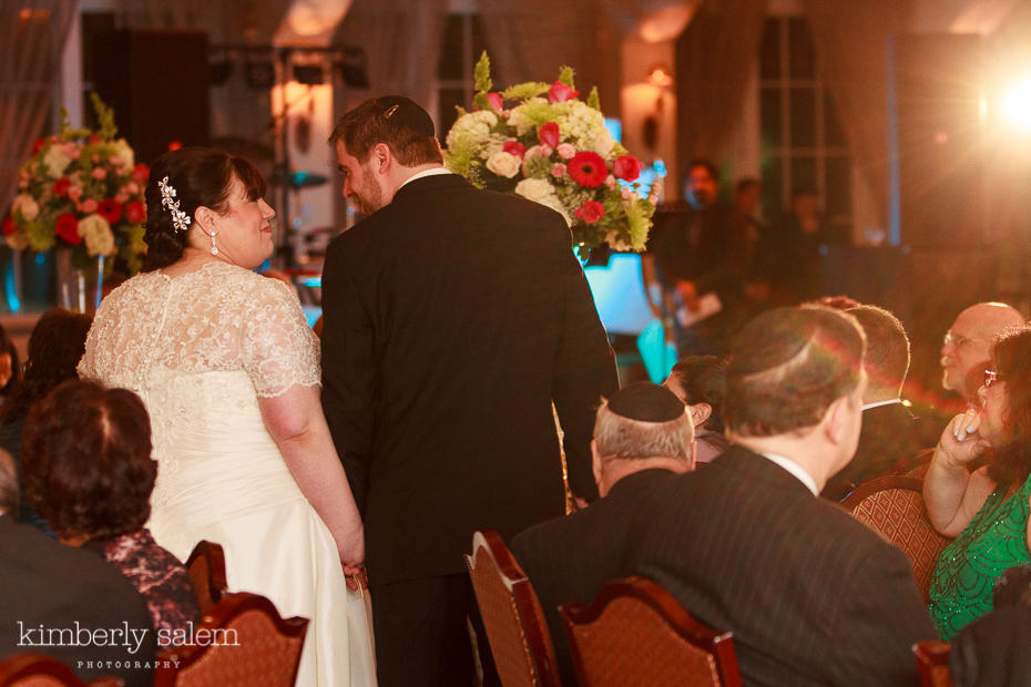 bride and groom share a sweet glance at the reception