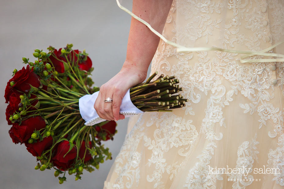 wedding bouquet detail with wedding rings and dress