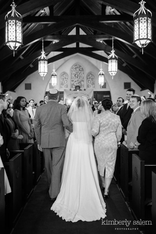 bride and her parents walking down the aisle