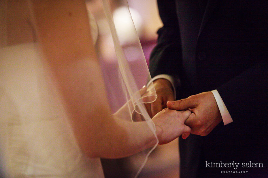 bride and groom hold hands