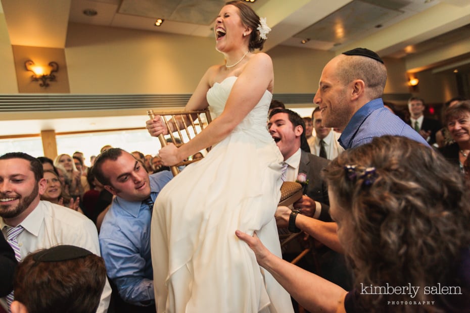 bride on chair during hora