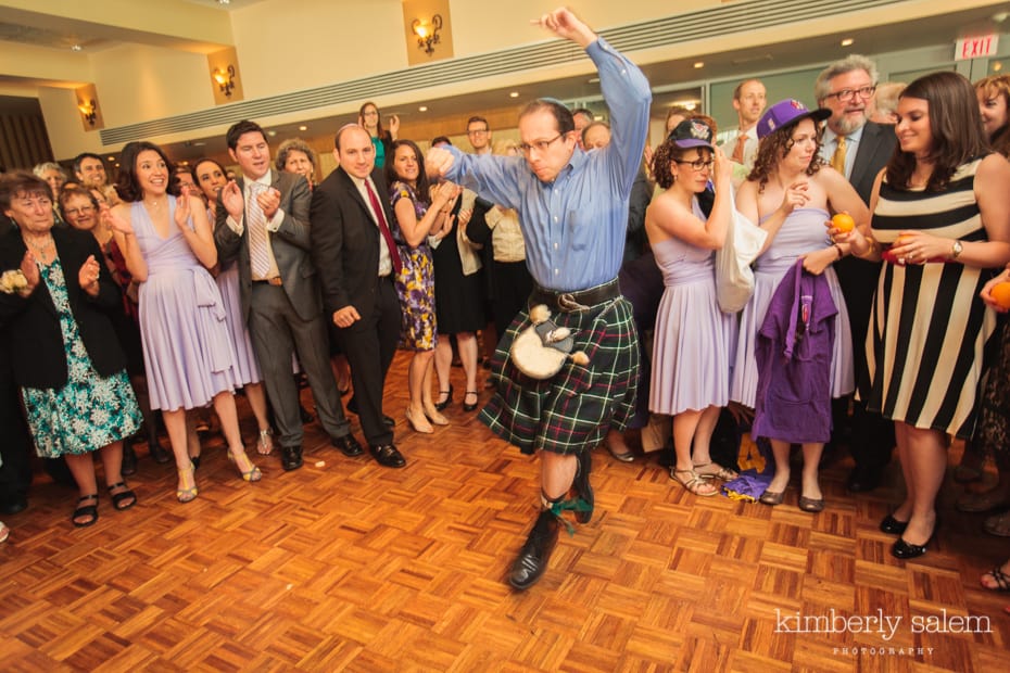 wedding guest in kilt dancing