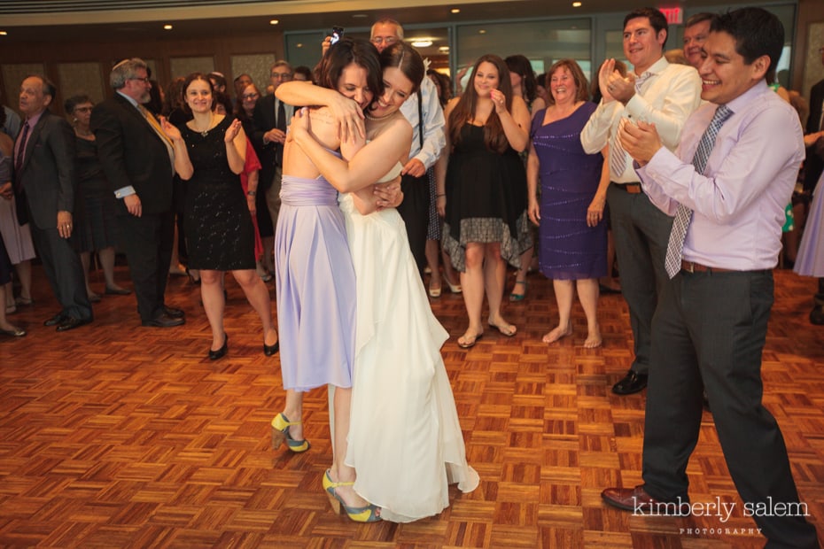 bride hugs her sister at reception