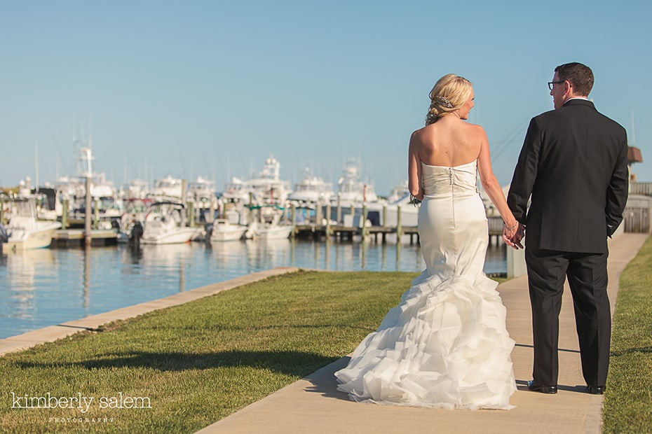 Bride and groom with boats in the background