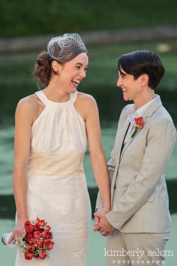 two brides laughing during their wedding ceremony